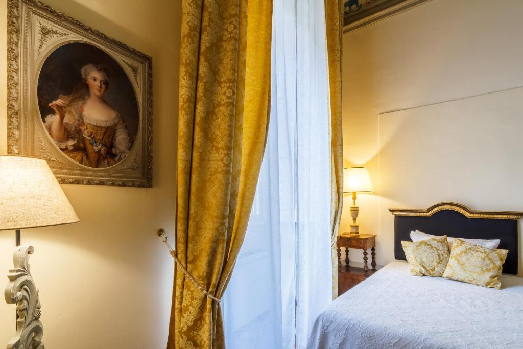 Postel nebo postele na pokoji v ubytování Dimora Storica Palazzo Puccini