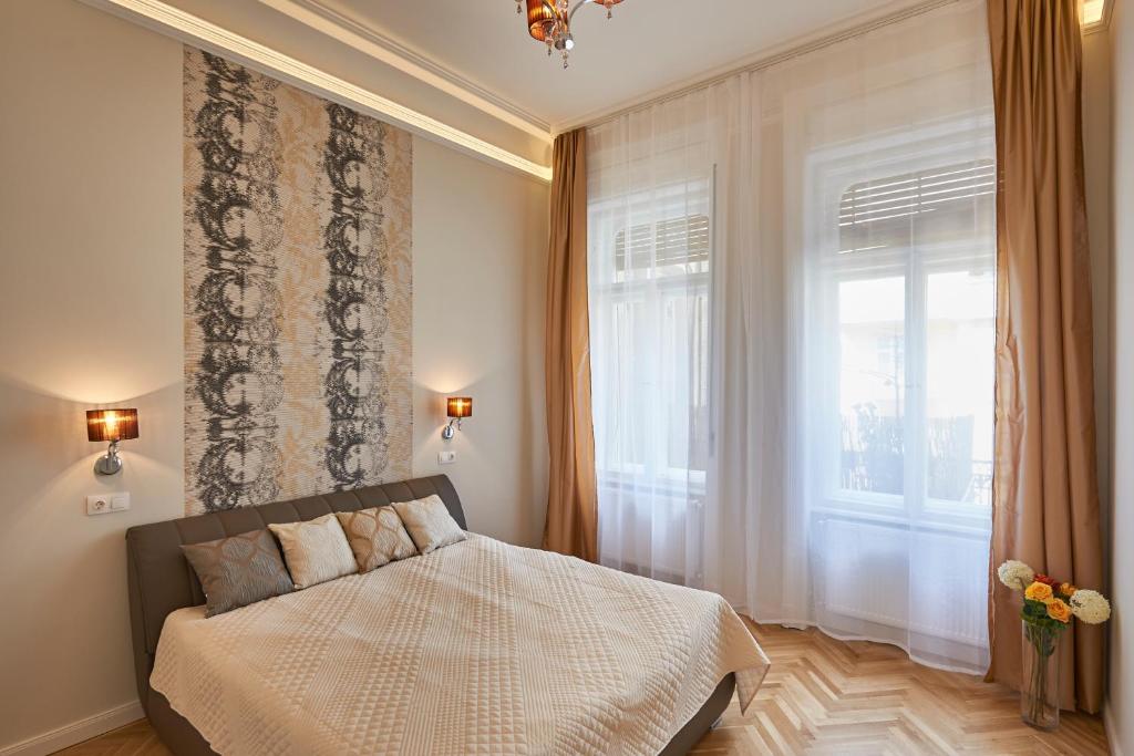 Posteľ alebo postele v izbe v ubytovaní Falk Miksa Apartment