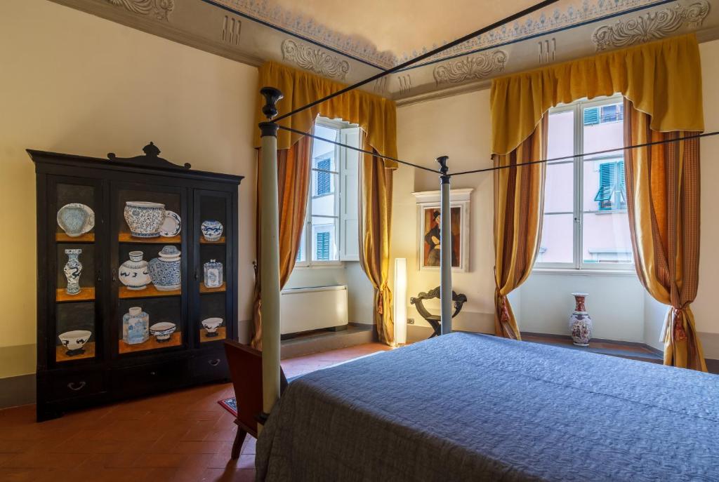 Postel nebo postele na pokoji v ubytování Dimora Storica Palazzo Puccini