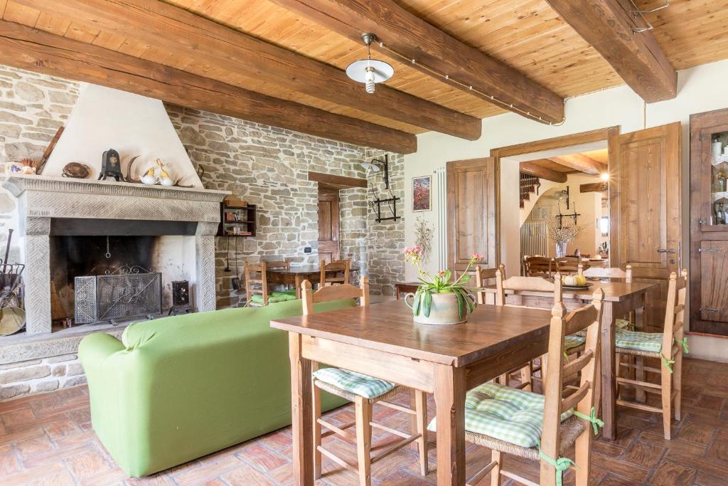 a living room with a table and a fireplace at Pianconvento La casa di Noi in Santa Sofia