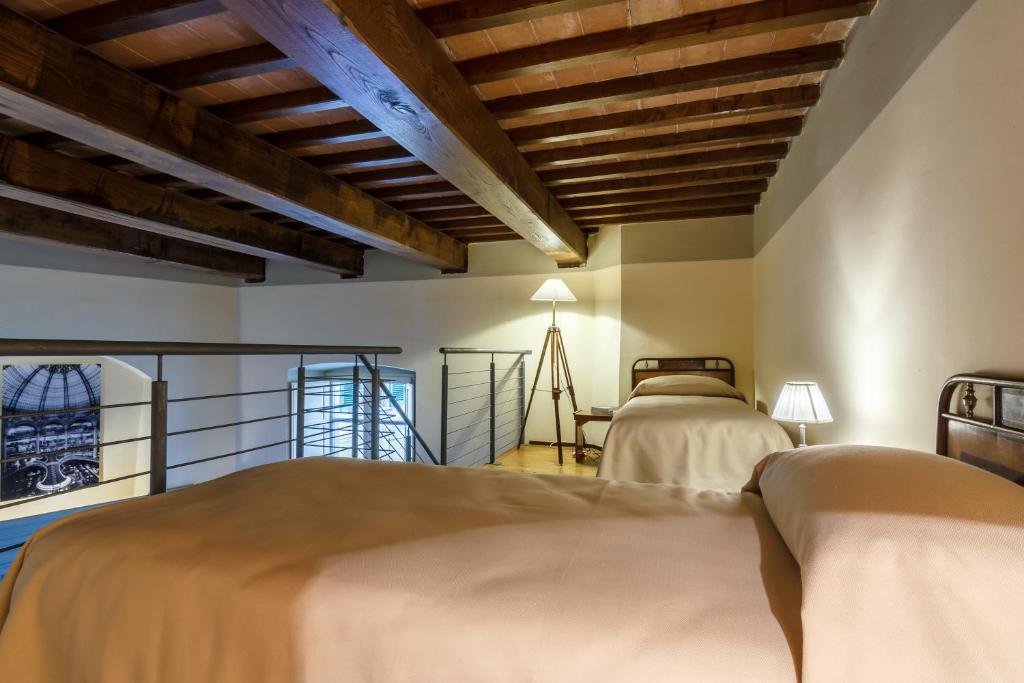 Postel nebo postele na pokoji v ubytování Dimora Storica Palazzo Puccini