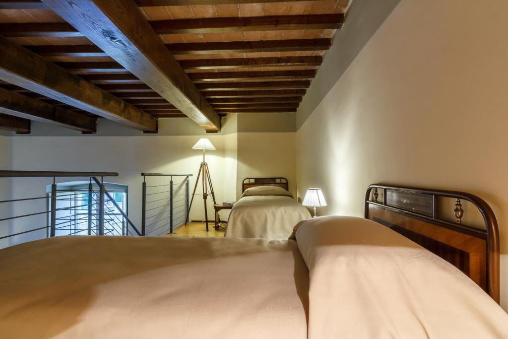 Postel nebo postele na pokoji v ubytování Dimora Storica Palazzo Puccini