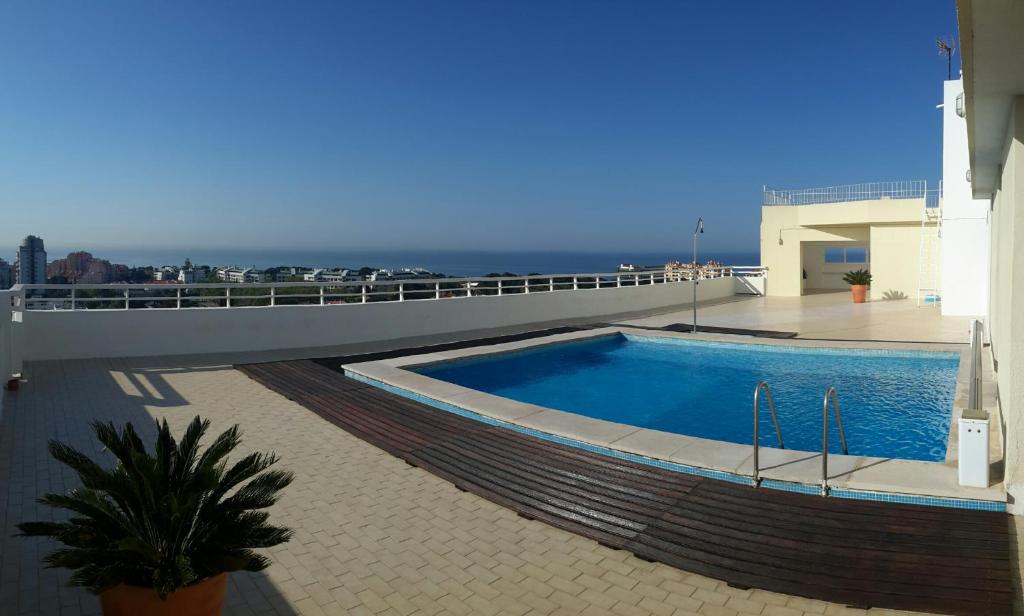 a swimming pool on the roof of a building at Torre Mar Apartment in Cascais