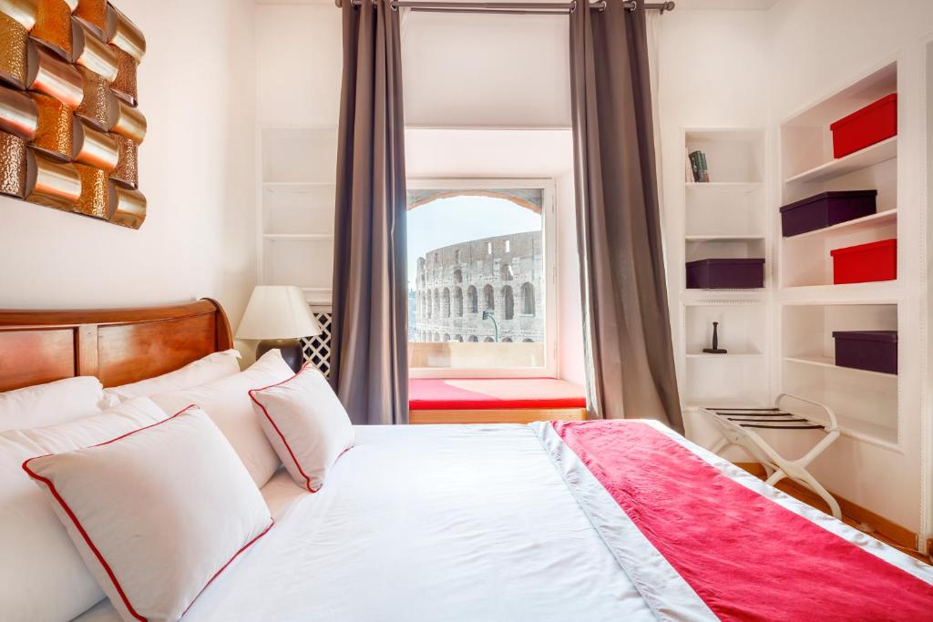 a bedroom with a bed and a large window at HT N°9 Colosseo in Rome