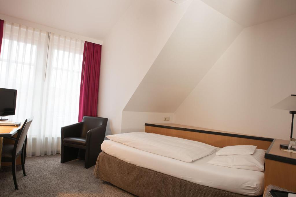 Postel nebo postele na pokoji v ubytování Hotel Schere