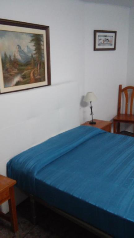 Postel nebo postele na pokoji v ubytování Hostal Porta De Núria