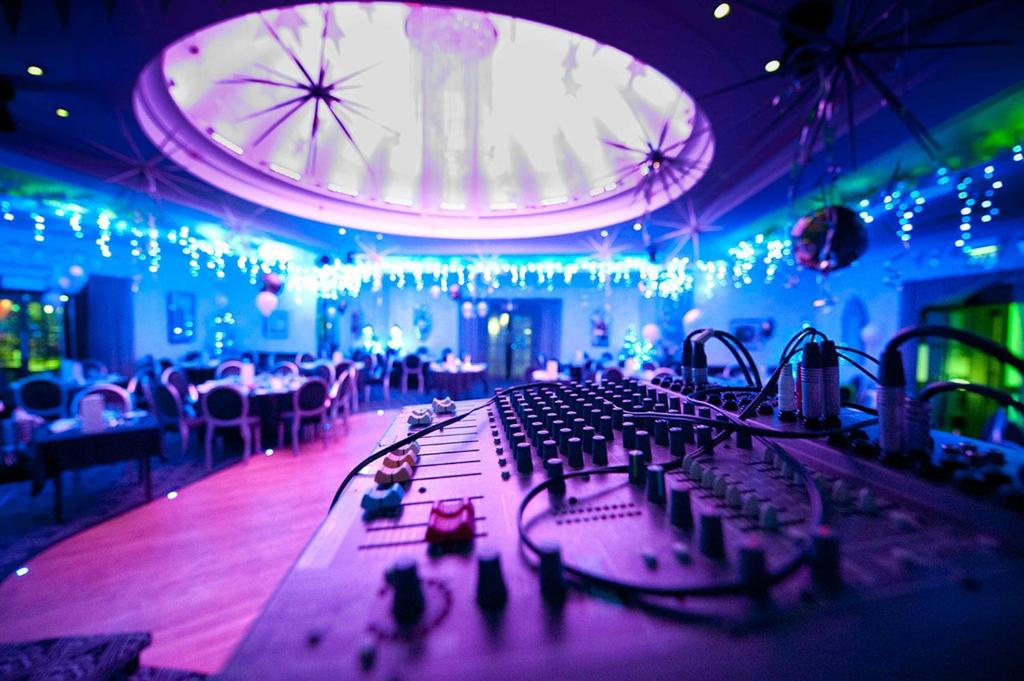 a room with a stage with chairs and lights at Cumberland Hotel - OCEANA COLLECTION in Bournemouth