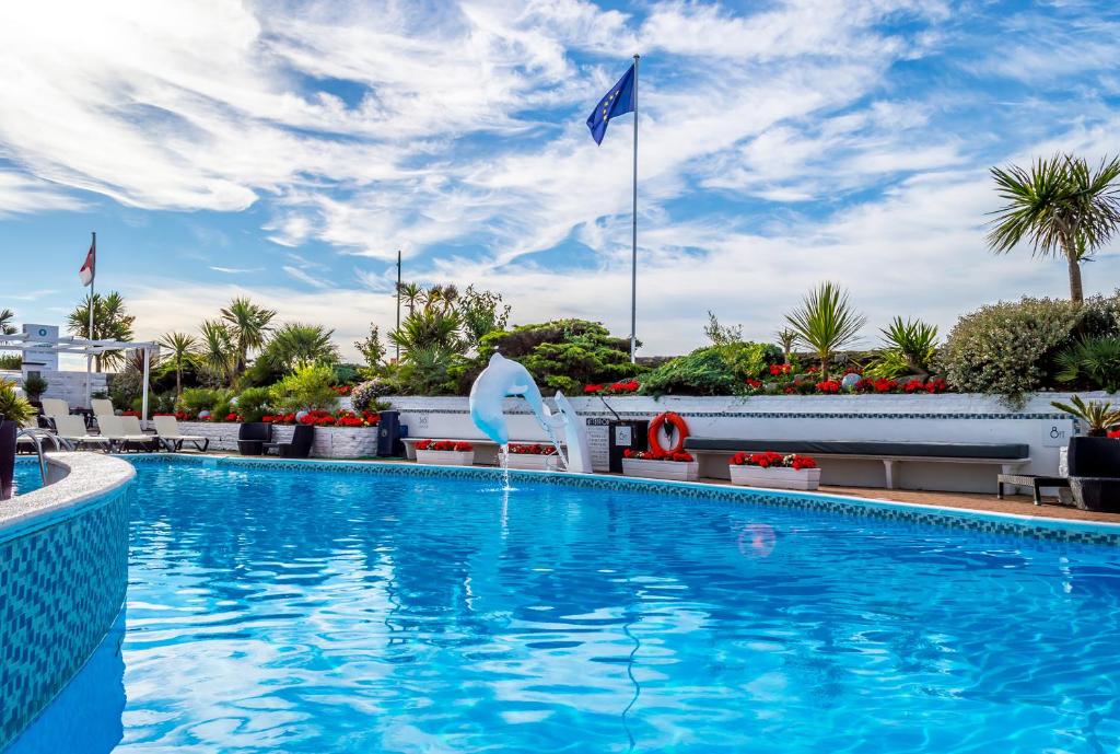 a swimming pool at a hotel with a sky background at Cumberland Hotel - OCEANA COLLECTION in Bournemouth