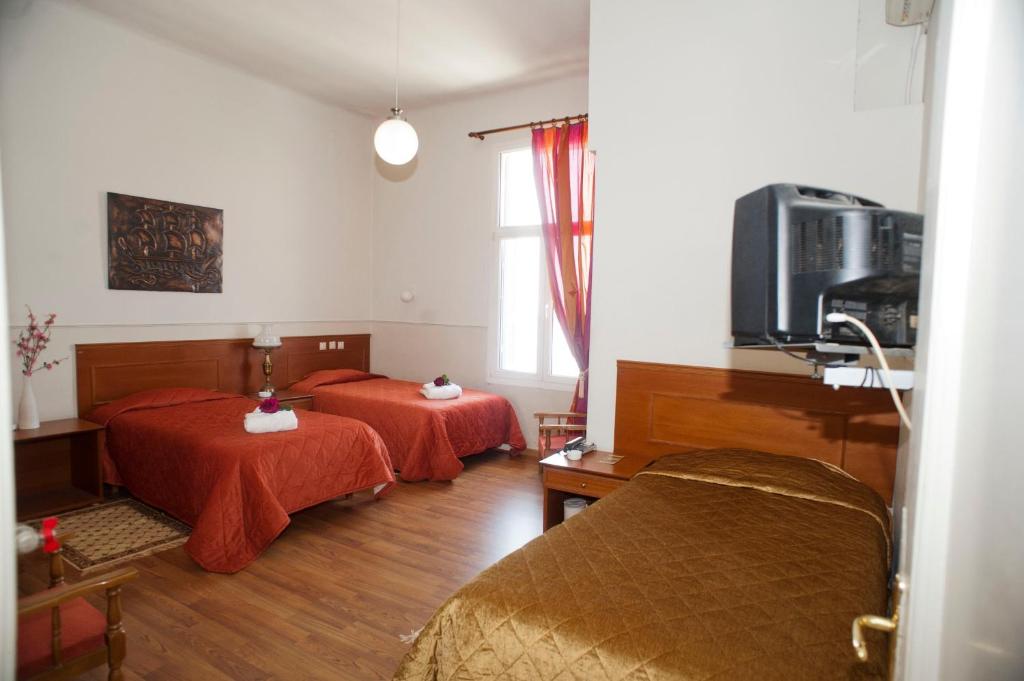 Postel nebo postele na pokoji v ubytování Hotel Acropolis