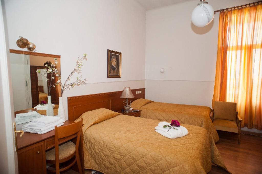 Postel nebo postele na pokoji v ubytování Hotel Acropolis