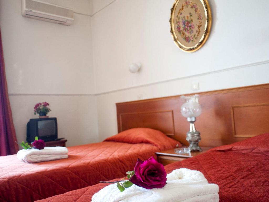 Postel nebo postele na pokoji v ubytování Hotel Acropolis