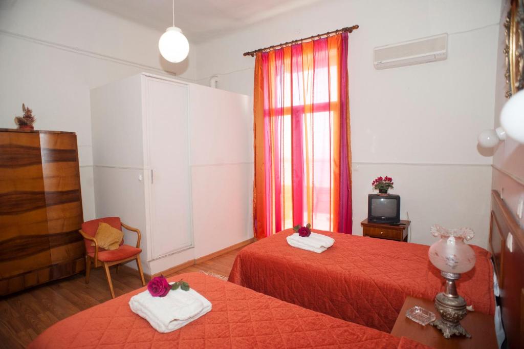 Postel nebo postele na pokoji v ubytování Hotel Acropolis