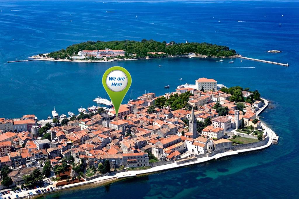 an island with a hot air balloon in the water at San Eleuterio Guesthouse in Poreč