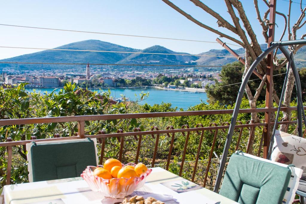 a table with a bowl of oranges on a balcony at Apartment Tina in Trogir