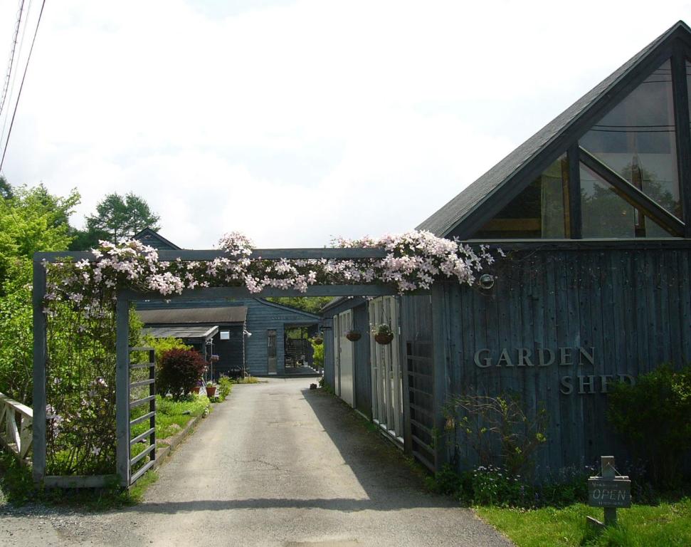 an entrance to a garden shed with flowers on it at Garden Shed in Yamanakako