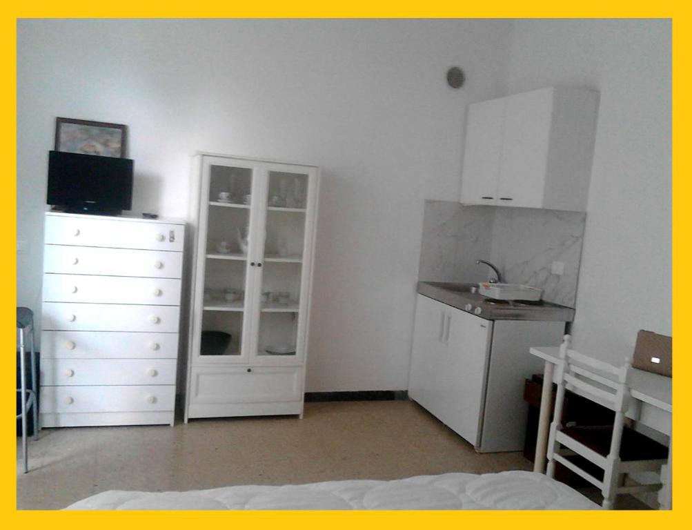 a bedroom with a white dresser and a white cabinet at Residence Rotonda in Savignano sul Rubicone