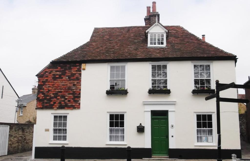 a white house with a green door at St Peters Bed and Breakfast in Sandwich