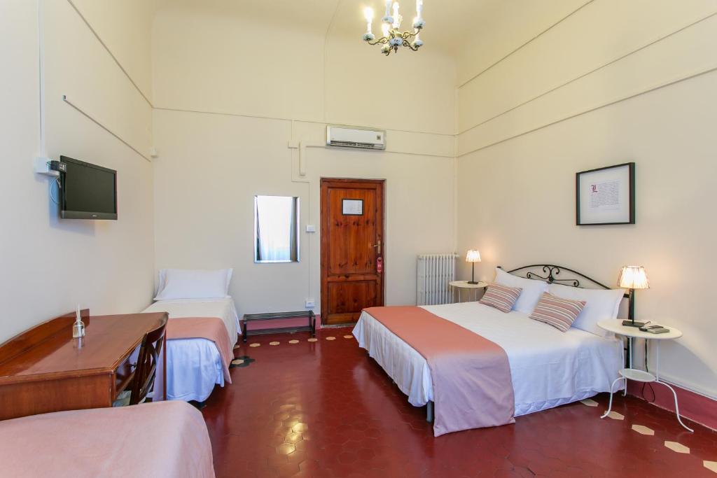 Postel nebo postele na pokoji v ubytování Hotel d'Azeglio Firenze