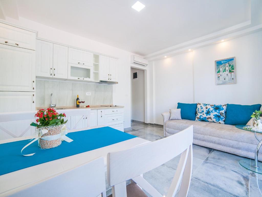 a kitchen and living room with a table and a couch at Apartments Castello in Kotor