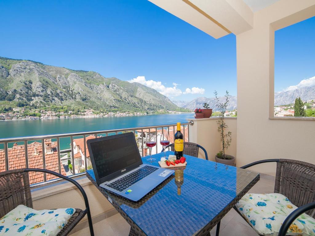 a laptop on a table with a view of the water at Apartments Castello in Kotor