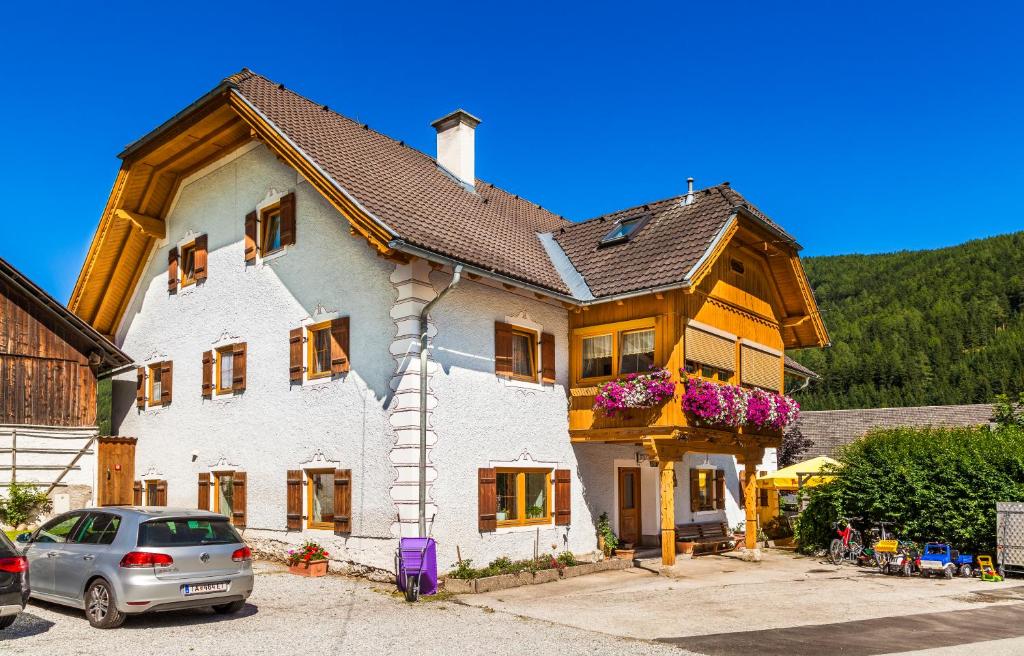 a house with a car parked in front of it at Grillhof-Gut in Mauterndorf