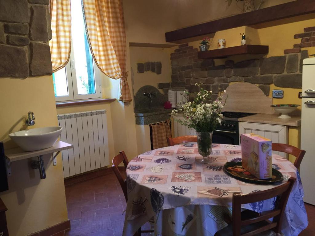 a kitchen with a table with a cake on it at Casa Monica Capoliveri in Capoliveri