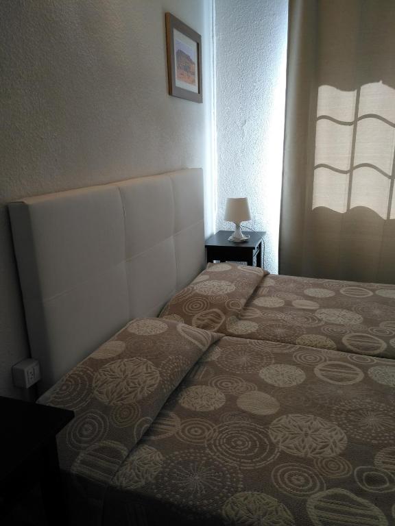 Postel nebo postele na pokoji v ubytování Hostal Porta De Núria