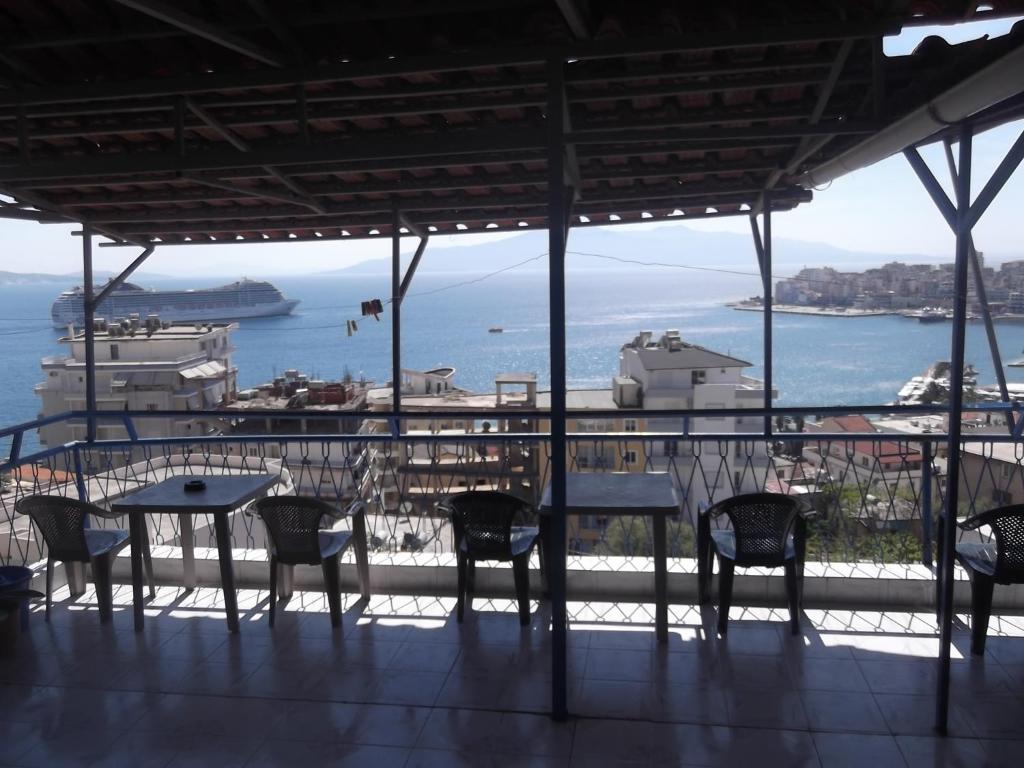 a table and chairs with a view of the ocean at Hotel Gjika in Sarandë