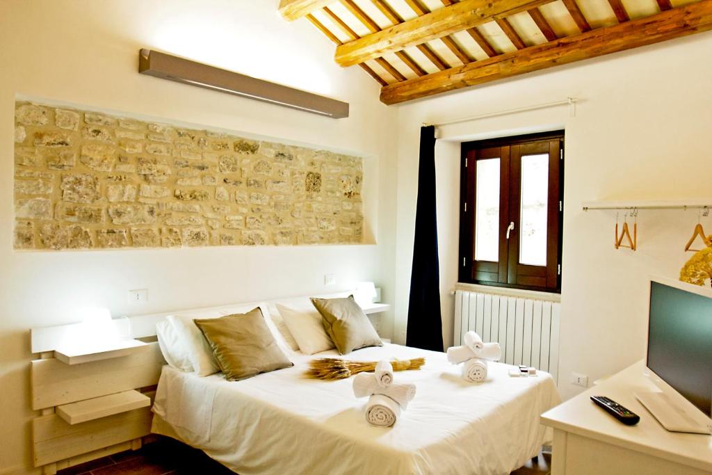 En eller flere senge i et værelse på Residence San Martino