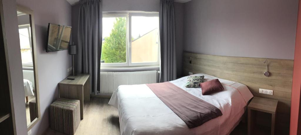 Postel nebo postele na pokoji v ubytování L'Hôtel des Bords de L'ill