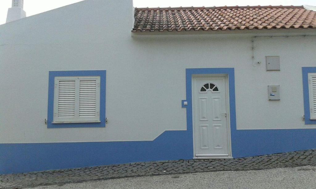 une maison bleue et blanche avec une porte et des fenêtres blanches dans l'établissement Casas de Santo António, à Odeceixe