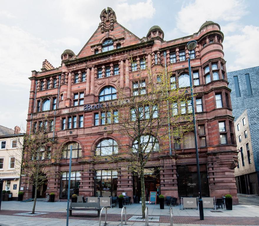 a large red brick building on a city street at ABode Manchester in Manchester