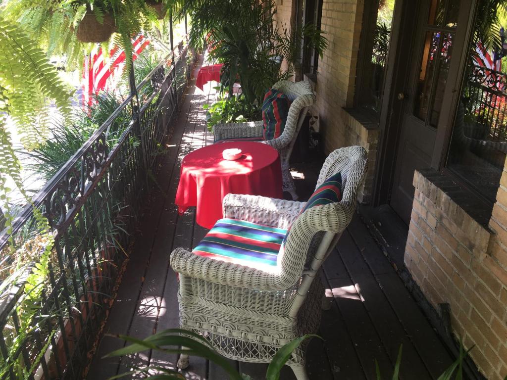 a patio with two chairs and a red table at Park Plaza Hotel Orlando - Winter Park in Orlando