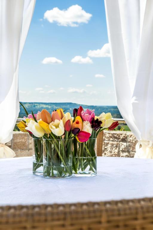 two vases filled with flowers sitting on a table at Hotel-Restaurant Distlerhof in Leinburg
