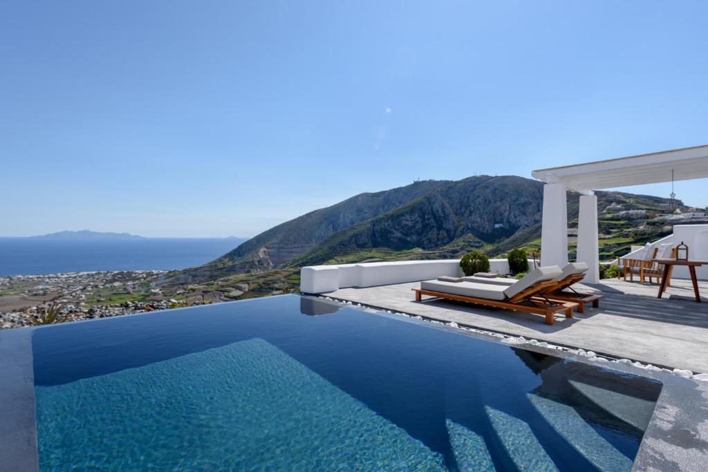 a villa with a pool and a view of the ocean at Andromaches - by Senses Collection in Pirgos