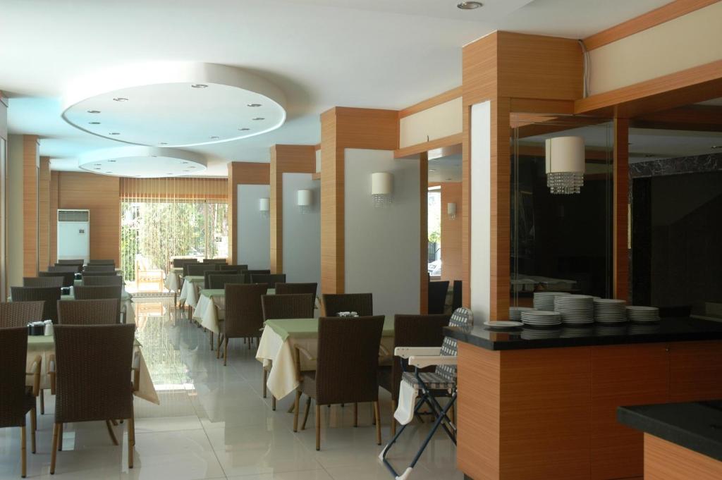 a dining room with tables and chairs in a restaurant at Suite Laguna Otel in Antalya