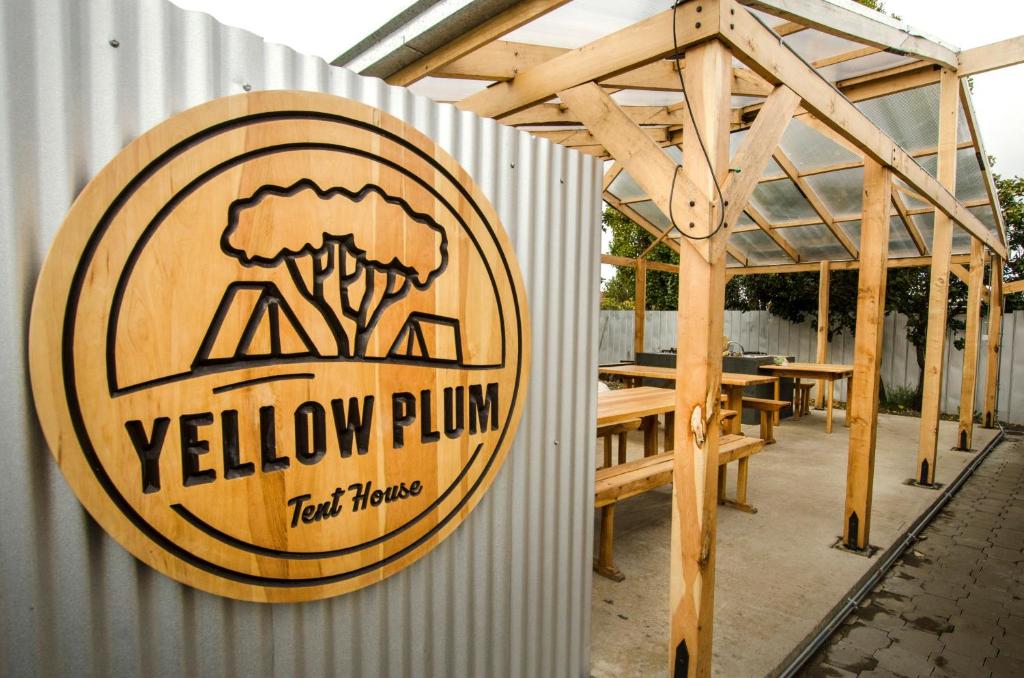 a sign on the side of a yellow plum tent house at Camping Yellow Plum in Puerto Natales