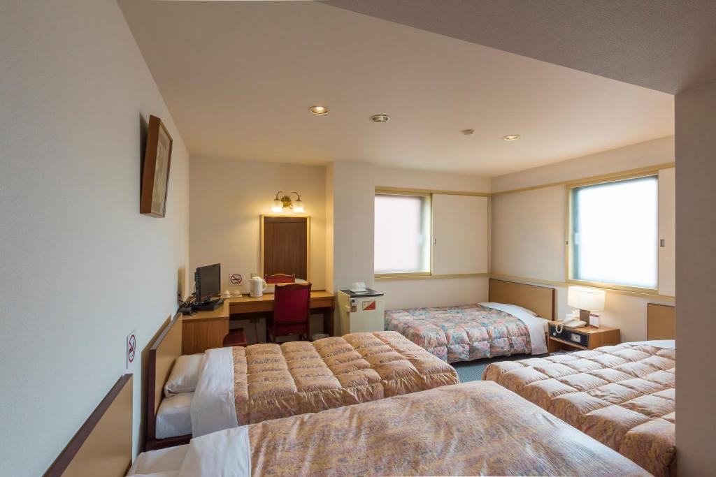 Postel nebo postele na pokoji v ubytování Oka Hotel