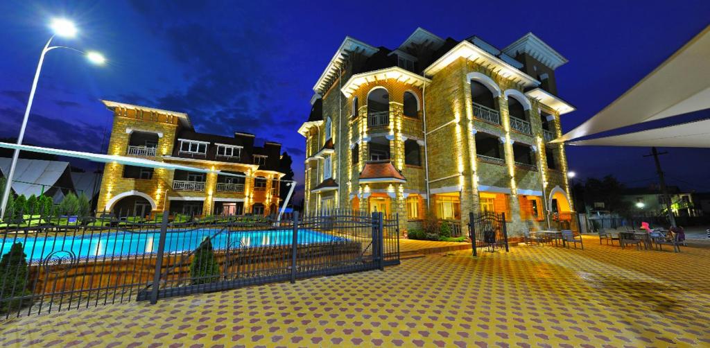 a large building with a pool in front of it at Marseille Resort in Zatoka