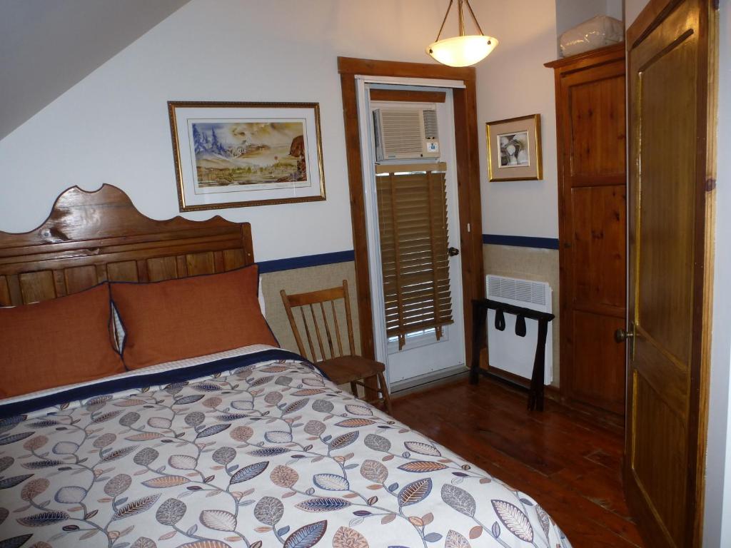 Rúm í herbergi á B&B Les Deux Pignons
