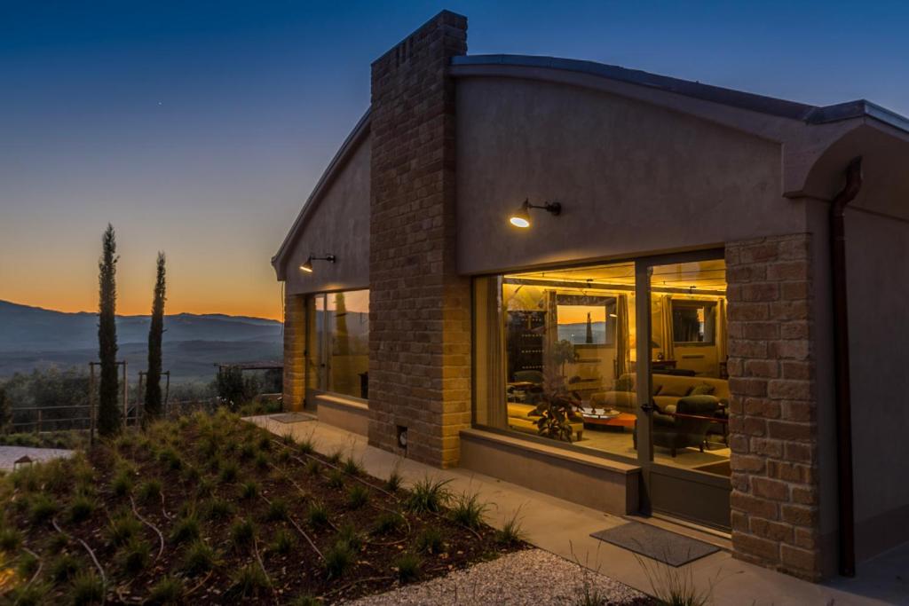 a brick house with a view of the sunset at A440 in Tuscany in Pienza