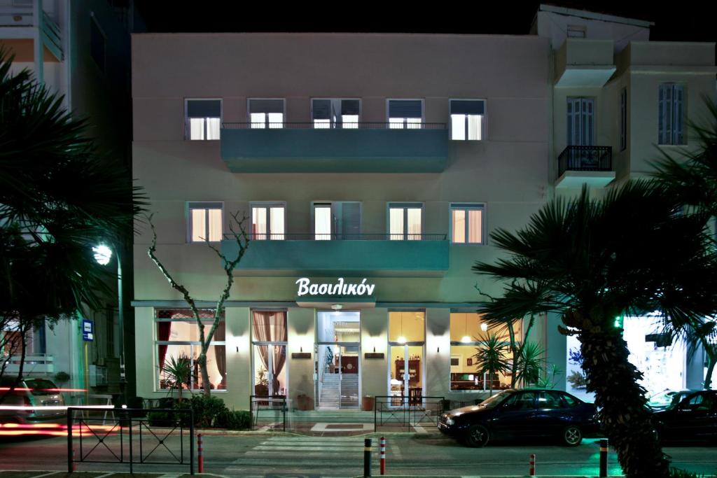 a building with a sign on the front of it at Vassilikon Hotel in Loutraki