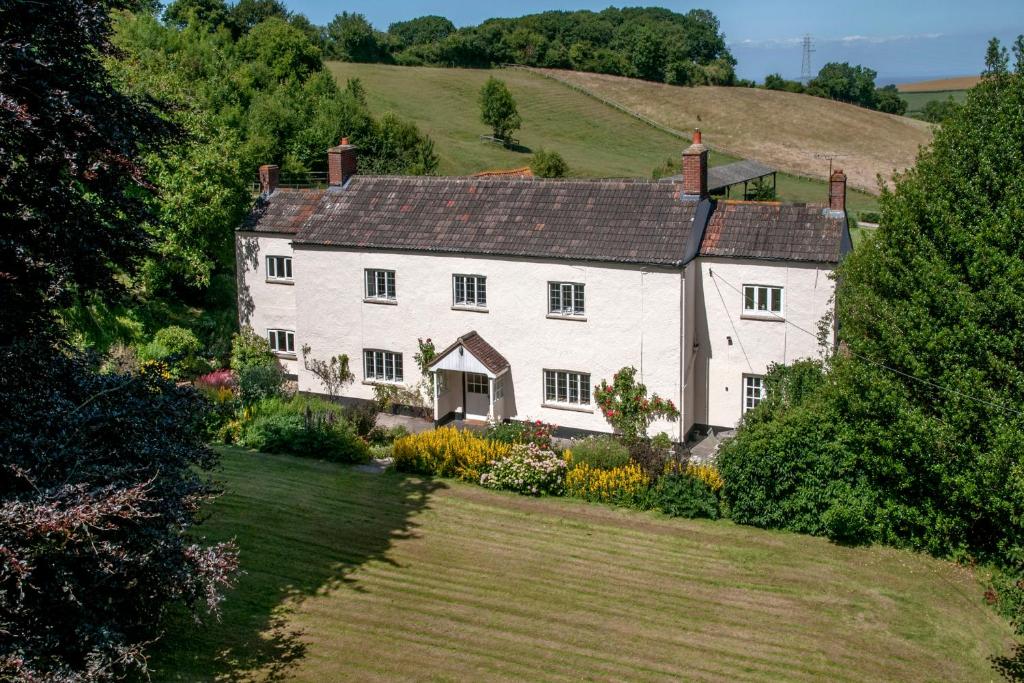 an aerial view of a large white house on a hill at Pardlestone Farm Cottages in Kilve