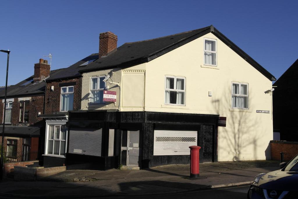 a white house with a garage in front of it at 55A Derbyshire Lane in Sheffield