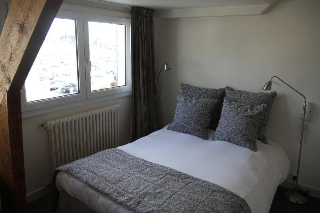 Postel nebo postele na pokoji v ubytování Hotel Le Suroit
