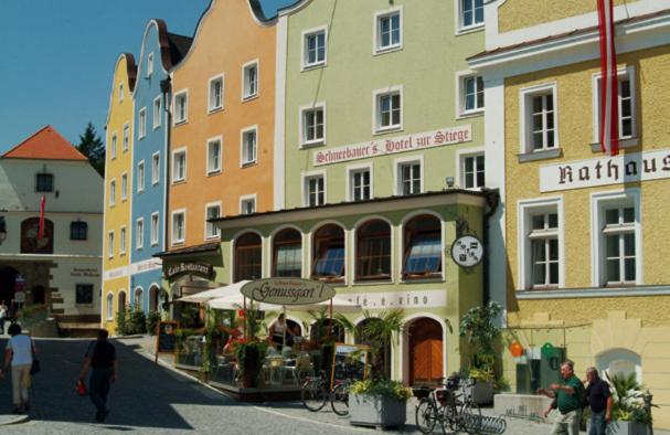 a group of buildings with people walking on a street at Hotel Stiegenwirt in Schärding