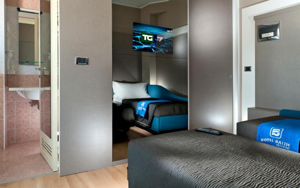 Postel nebo postele na pokoji v ubytování Hotel Baltic Riccione-Fronte Mare