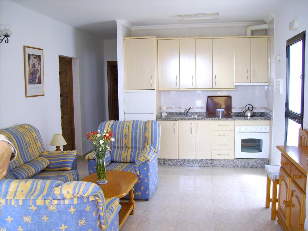 a living room with two couches and a kitchen at El Capistrano Sur in Nerja