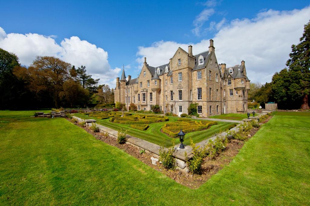 an old castle with a garden in front of it at Carberry Tower Mansion House and Estate in Musselburgh