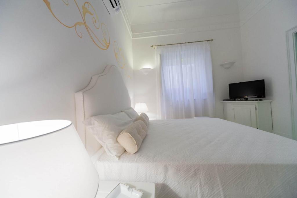 Cama o camas de una habitación en La Settima Luna Hotel